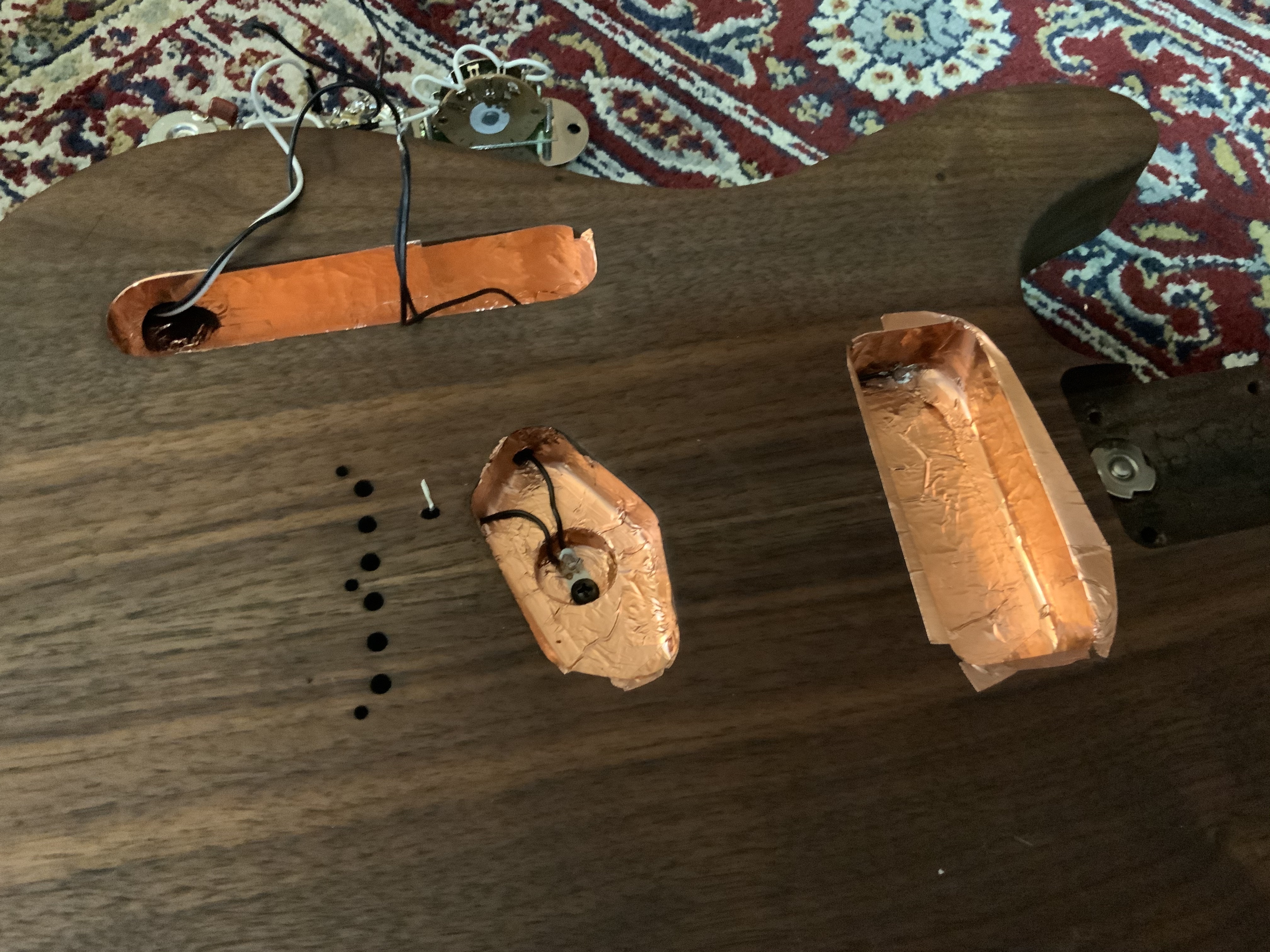 a guitar with pickups chambers insulated with copper tape